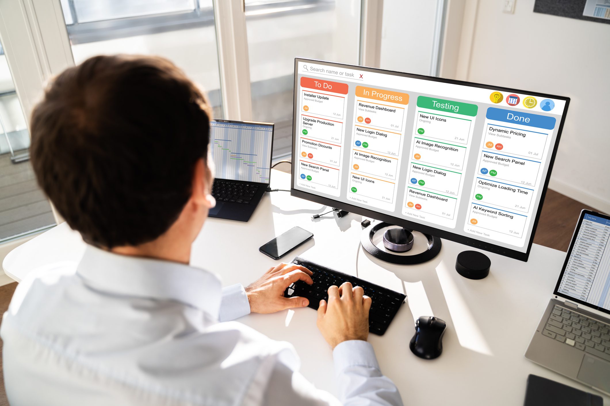 Person using multi-screen computer at desk.